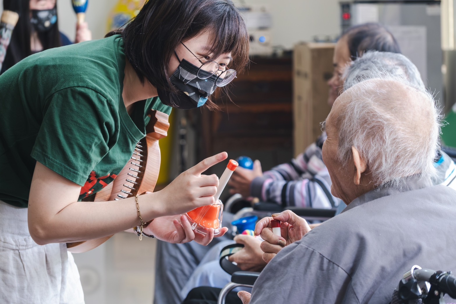 Seniors and music pathfinders making music together with instruments in the senior music care program.